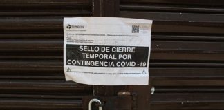 Piden a comerciantes no abrir en semáforo rojo