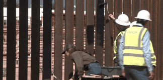 Pintan muro fronterizo de negro para quemarles las manos a migrantes y polleros